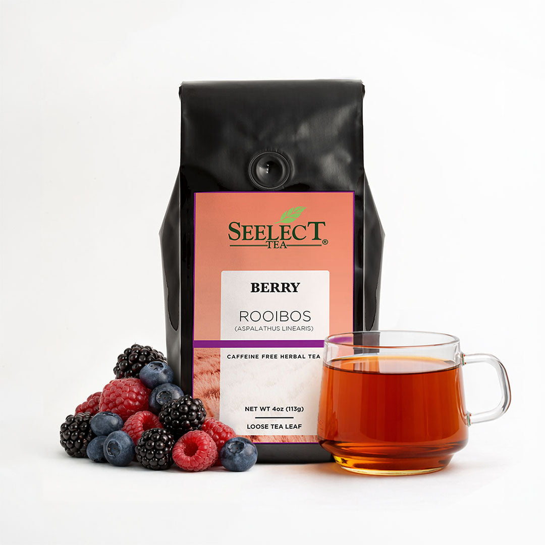 Berry Rooibos tea bag with 'Seelect Tea' label, cup of tea, and berries on a white background