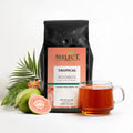 Seelect Tea Tropical Rooibos package with a cup of tea and tea leaves on a white background